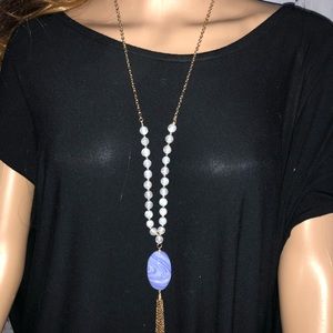 Gold necklace with blue and white stone